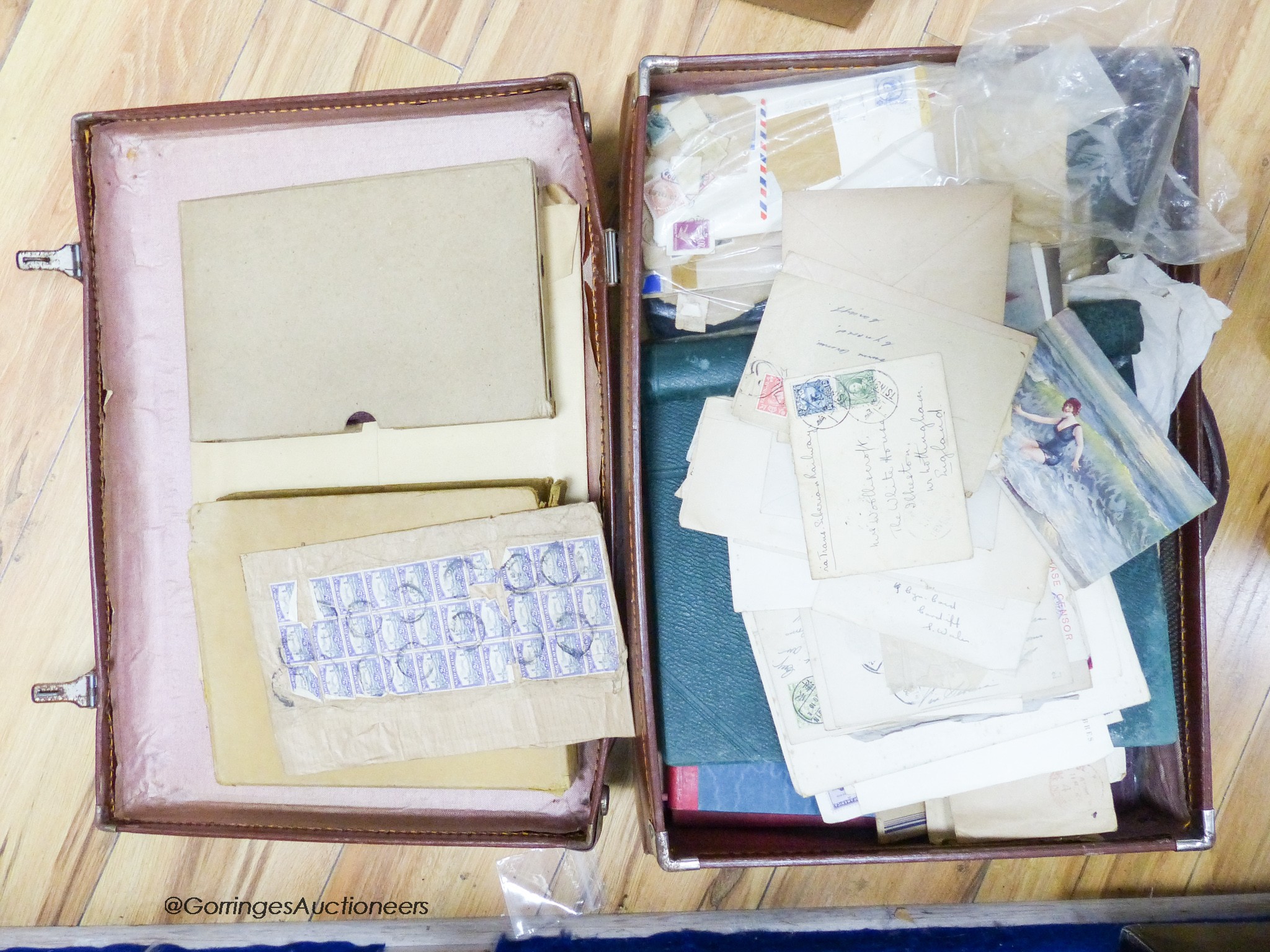 A suitcase of mostly early world stamps in albums packets with a 1937 coronation, 1945 victory album leaves, loose packets, some postal covers (affected by damp)
